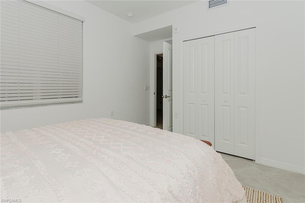 5445 Double Eagle Circle, Unit 3013 Ave Maria, FL 34142 - Photo 7 of 41 a large white bed in a white room