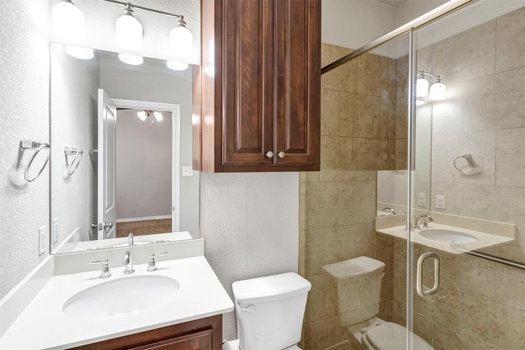 420 Prairie Run Aledo, TX 76008 - Photo 18 of 37 a bathroom with a sink a toilet a mirror and shower