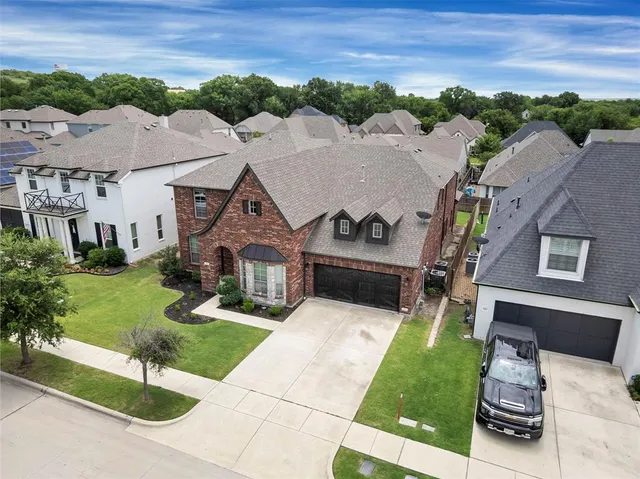 an aerial view of a house with swimming pool garden and outdoor seating
