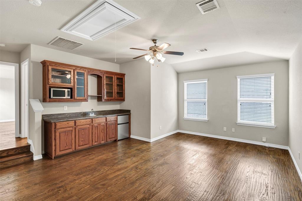 420 Prairie Run Aledo, TX 76008 - Photo 30 of 37 a kitchen with stainless steel appliances granite countertop a stove a sink dishwasher and a large window with wooden floor