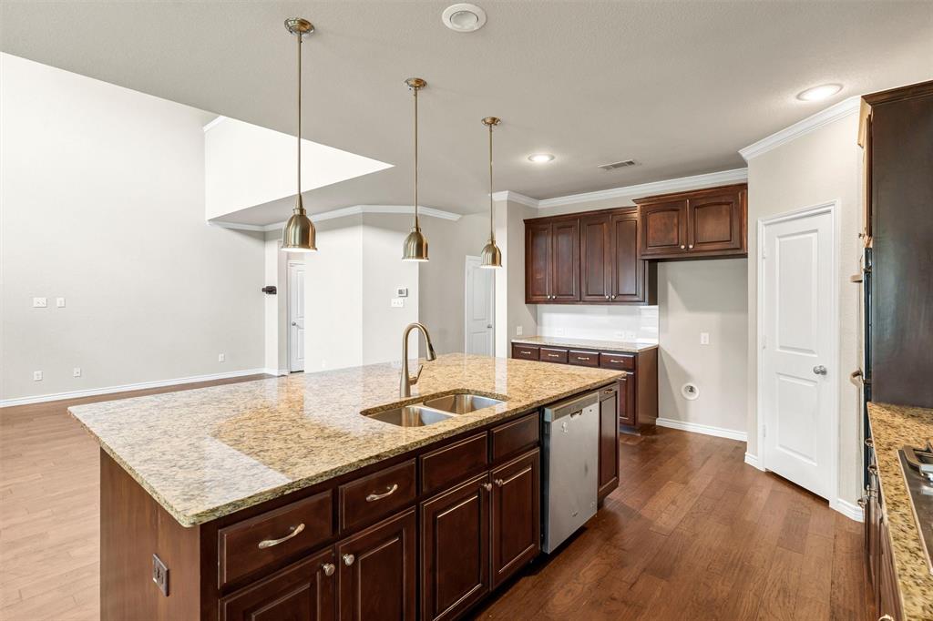 420 Prairie Run Aledo, TX 76008 - Photo 10 of 37 a kitchen with stainless steel appliances granite countertop cabinets a refrigerator a sink and wooden floor