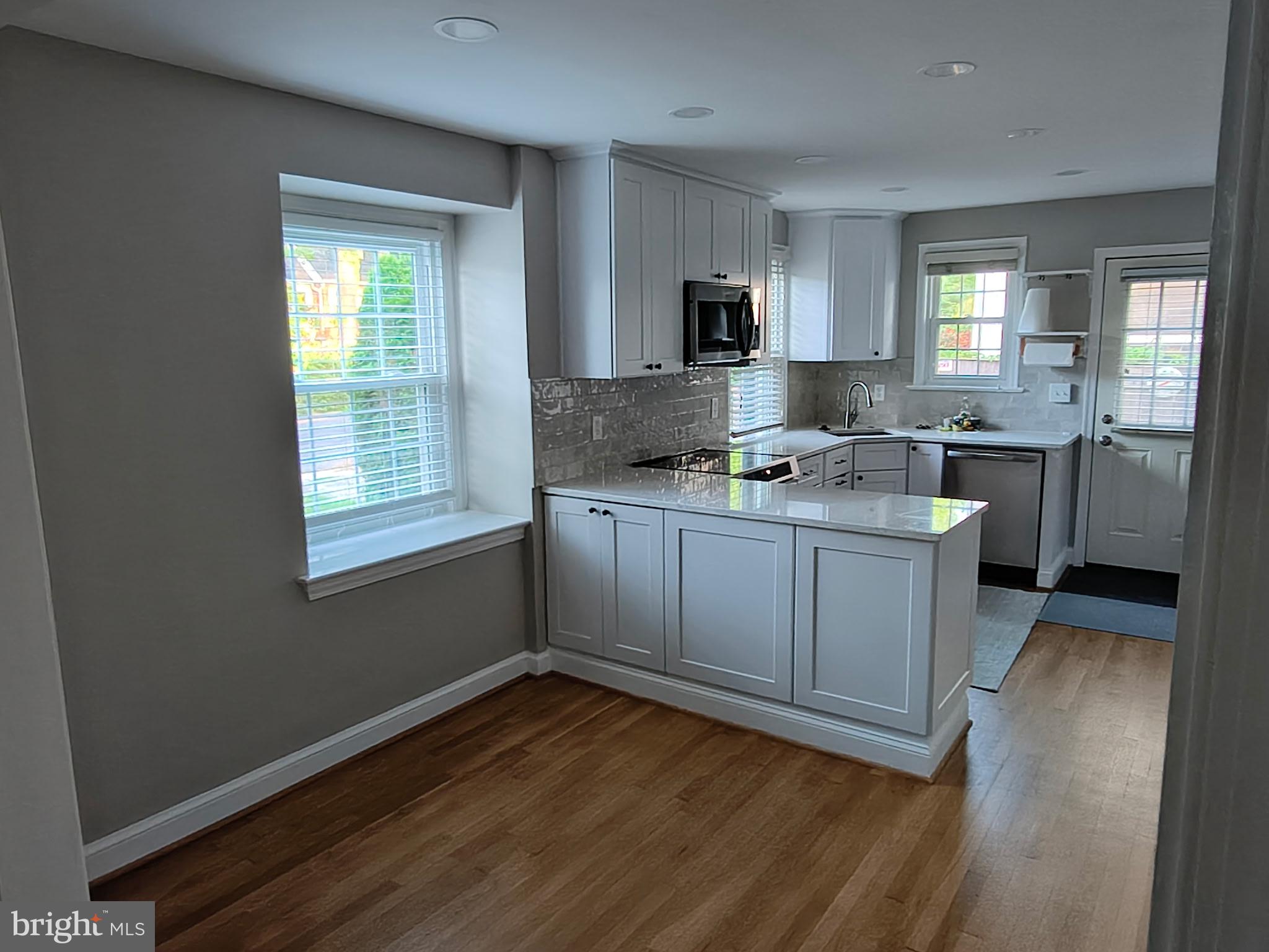 9316 Sudbury Road Silver Spring, MD 20901 - Photo 2 of 19 a kitchen with a sink stove and cabinets