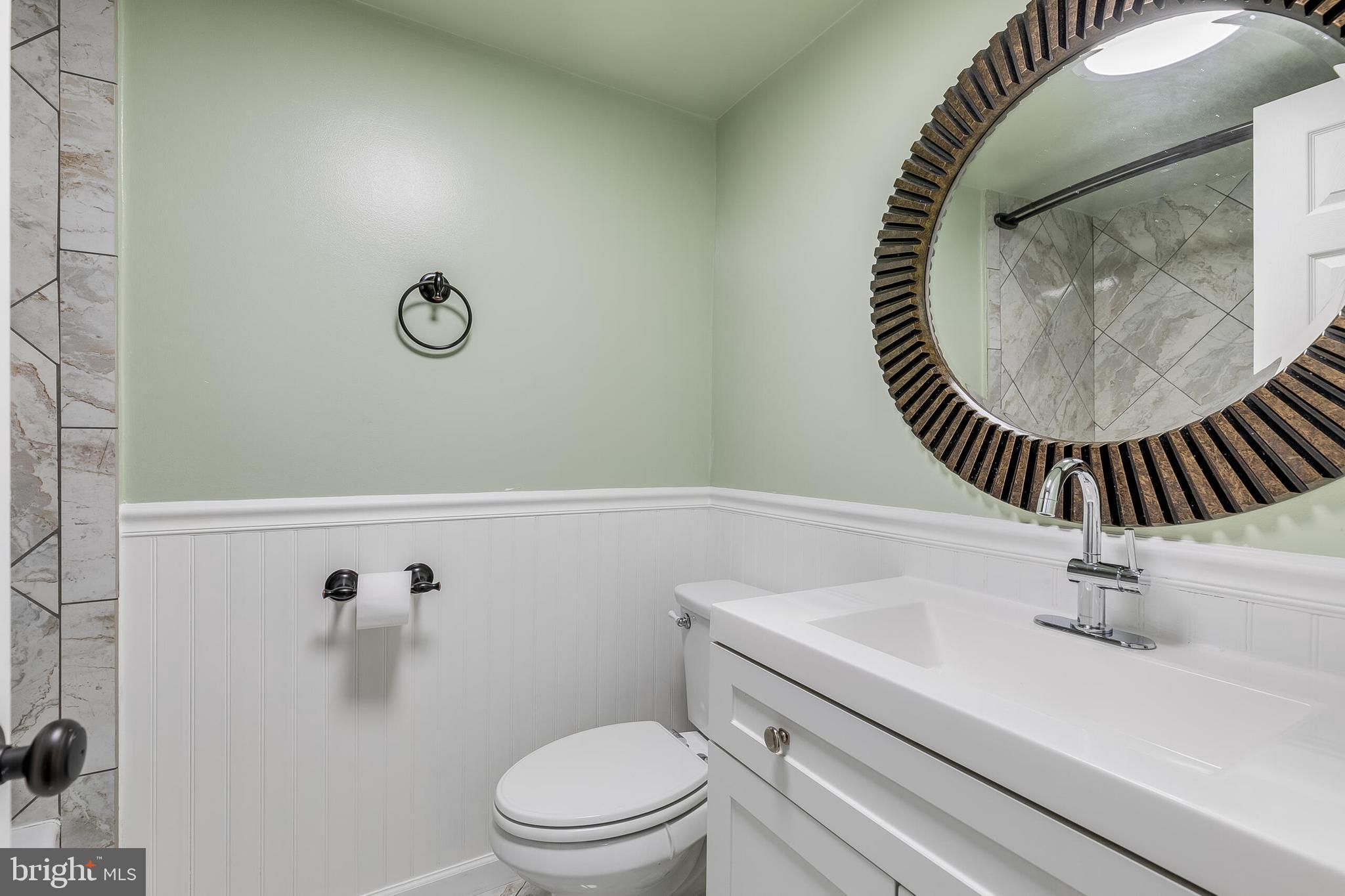 2255 Castle Rock Square, Unit 12C Reston, VA 20191 - Photo 13 of 29 a bathroom with a sink and mirror