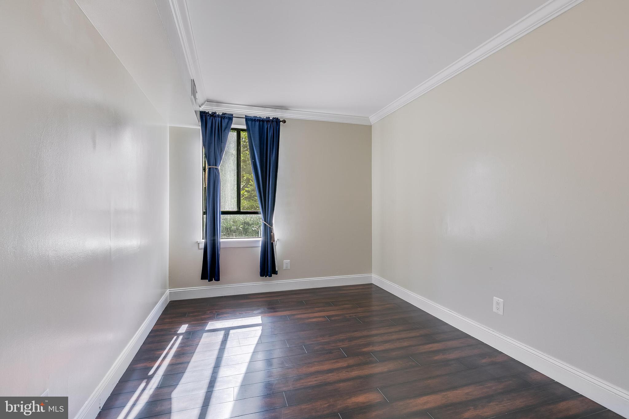 2255 Castle Rock Square, Unit 12C Reston, VA 20191 - Photo 16 of 29 a view of an empty room with wooden floor and a window