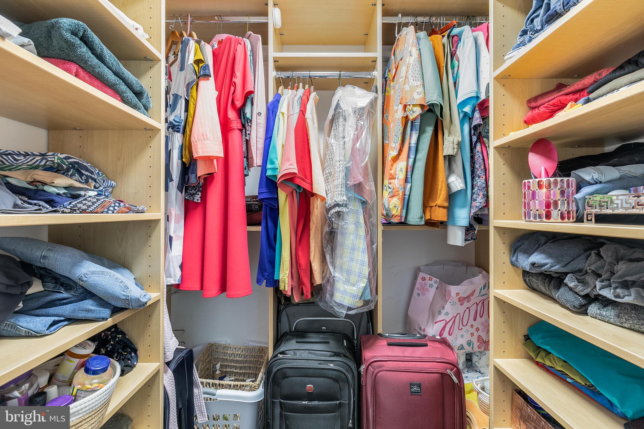 2255 Castle Rock Square, Unit 12C Reston, VA 20191 - Photo 21 of 29 a view of walk in closet with clothes and shoes