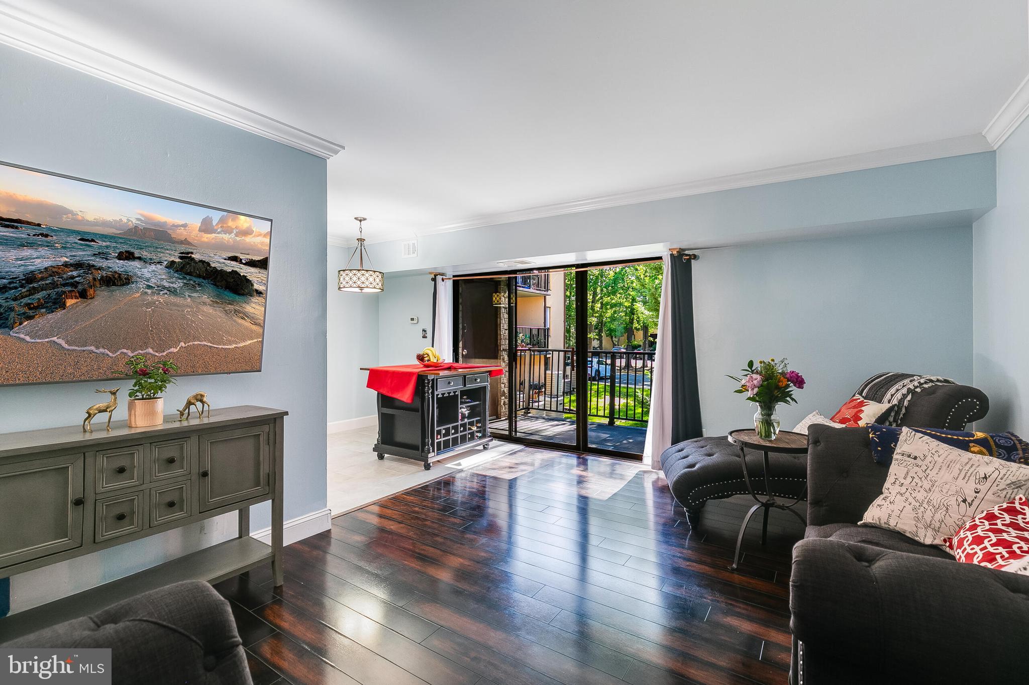 2255 Castle Rock Square, Unit 12C Reston, VA 20191 - Photo 5 of 29 a living room with furniture and a flat screen tv