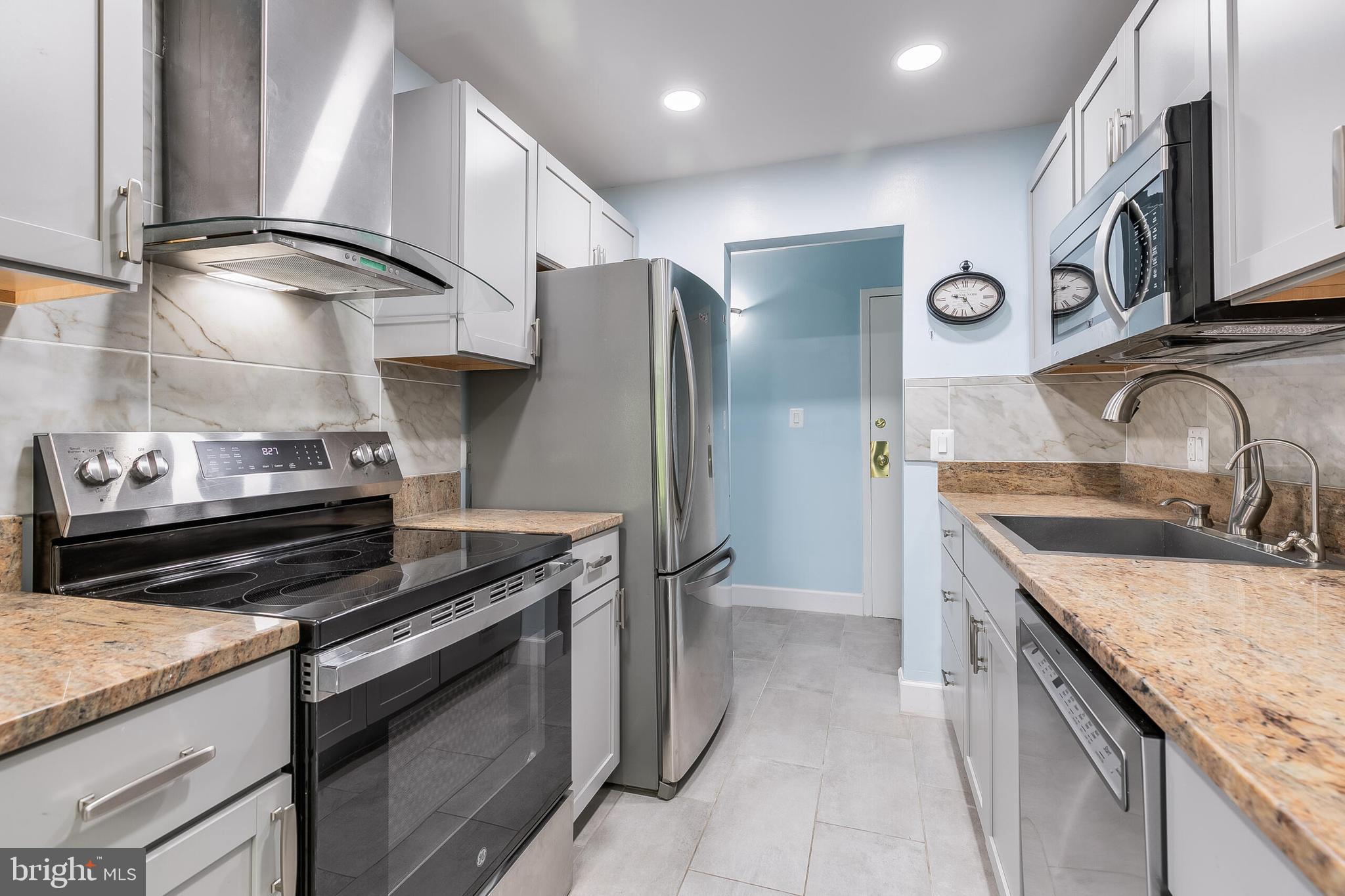 2255 Castle Rock Square, Unit 12C Reston, VA 20191 - Photo 6 of 29 a kitchen with stainless steel appliances granite countertop a sink and a stove