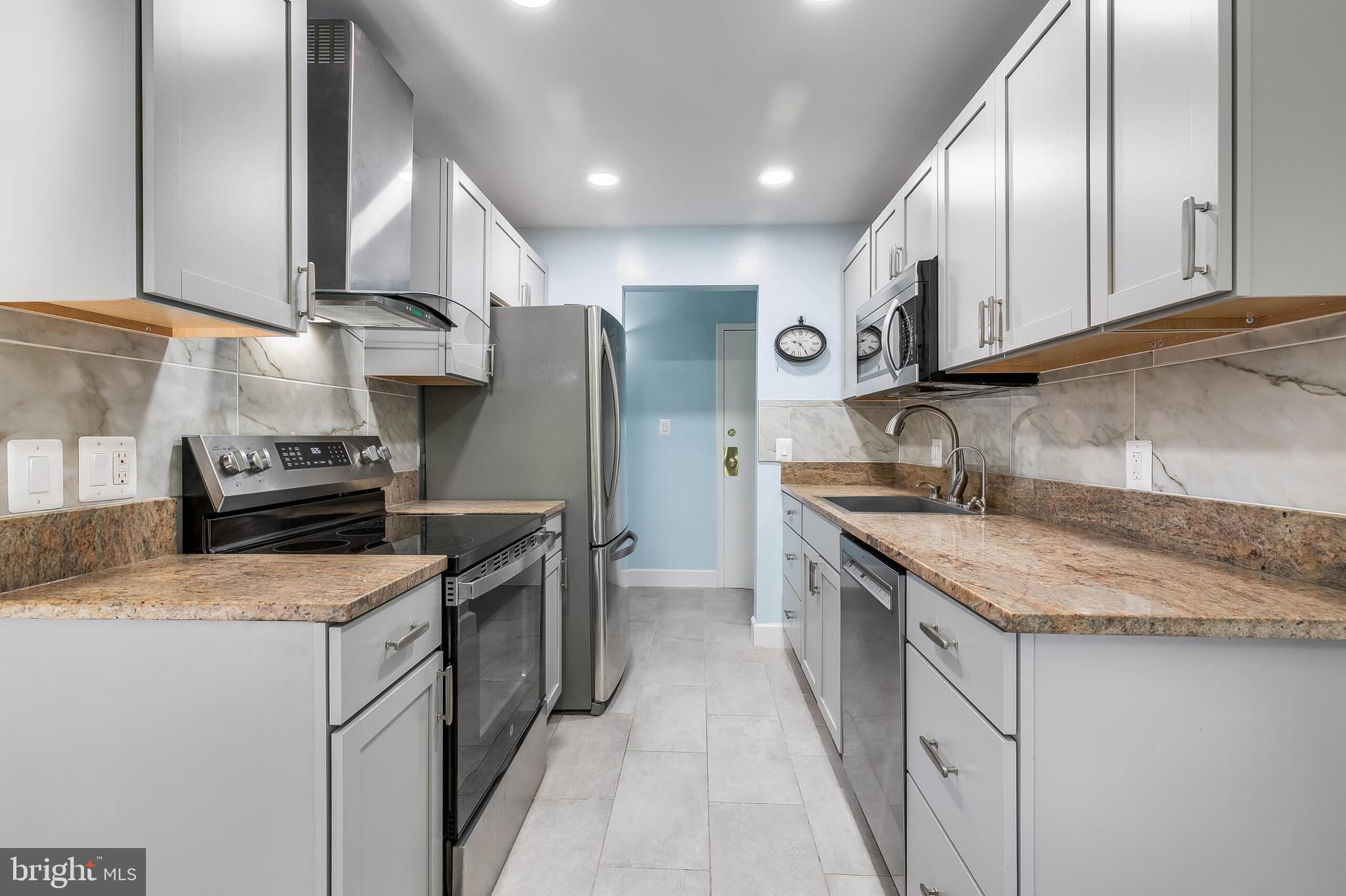2255 Castle Rock Square, Unit 12C Reston, VA 20191 - Photo 7 of 29 a kitchen with stainless steel appliances granite countertop a sink stove and refrigerator