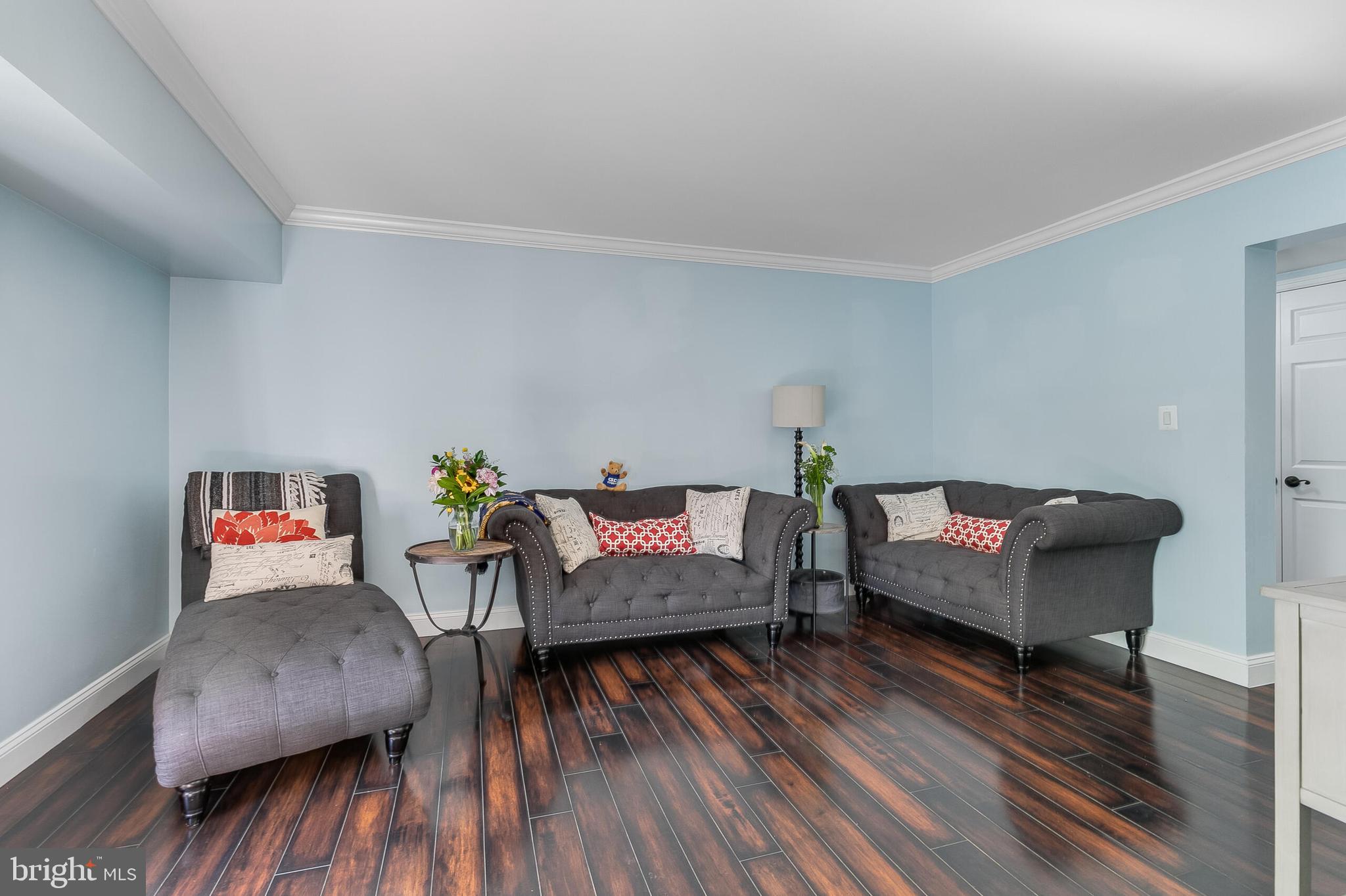 2255 Castle Rock Square, Unit 12C Reston, VA 20191 - Photo 8 of 29 a living room with furniture and a wooden floor