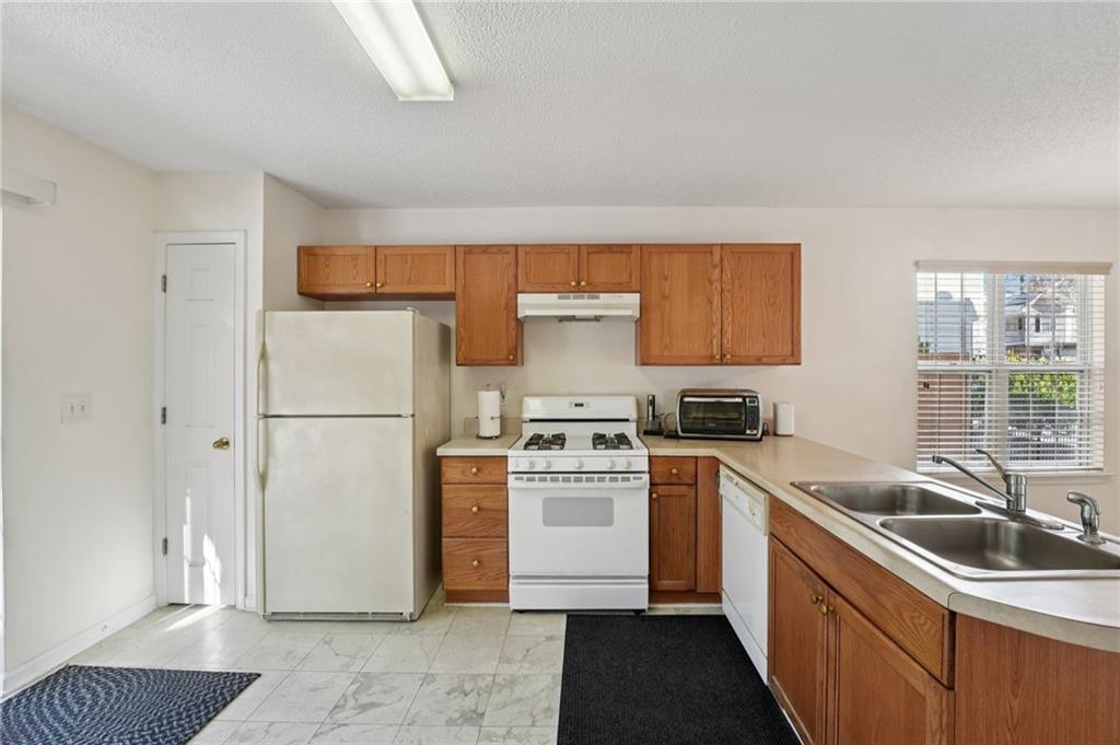 111 Bainbridge Court Dallas, GA 30132 - Photo 11 of 37 a kitchen with a stove a sink and a refrigerator