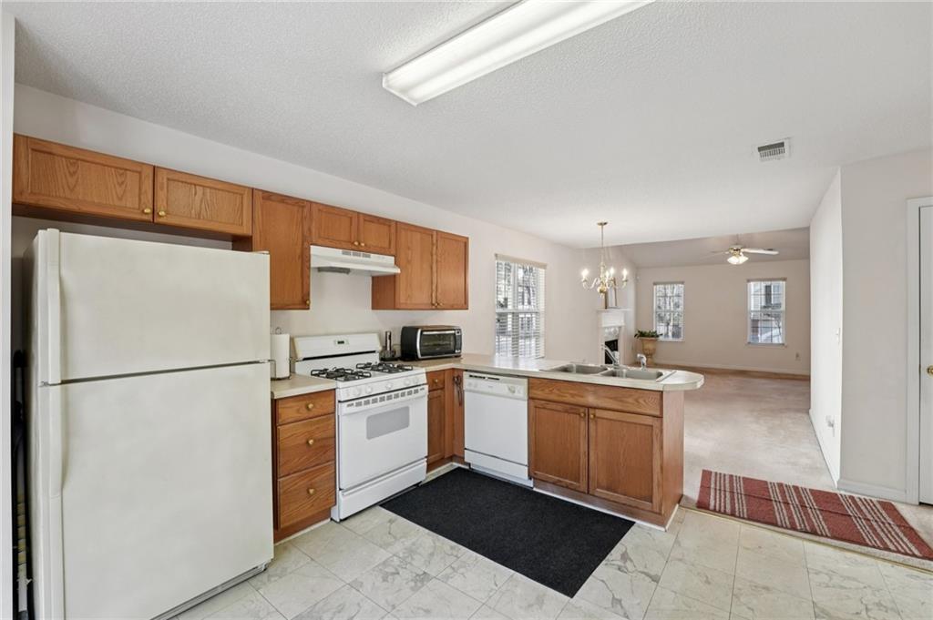 111 Bainbridge Court Dallas, GA 30132 - Photo 12 of 37 a kitchen with stainless steel appliances a refrigerator sink and white cabinets