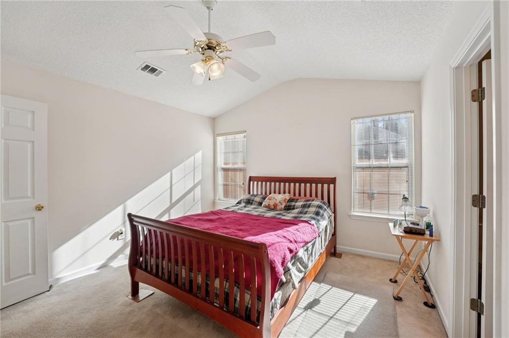 111 Bainbridge Court Dallas, GA 30132 - Photo 14 of 37 a bedroom with a bed and a chandelier