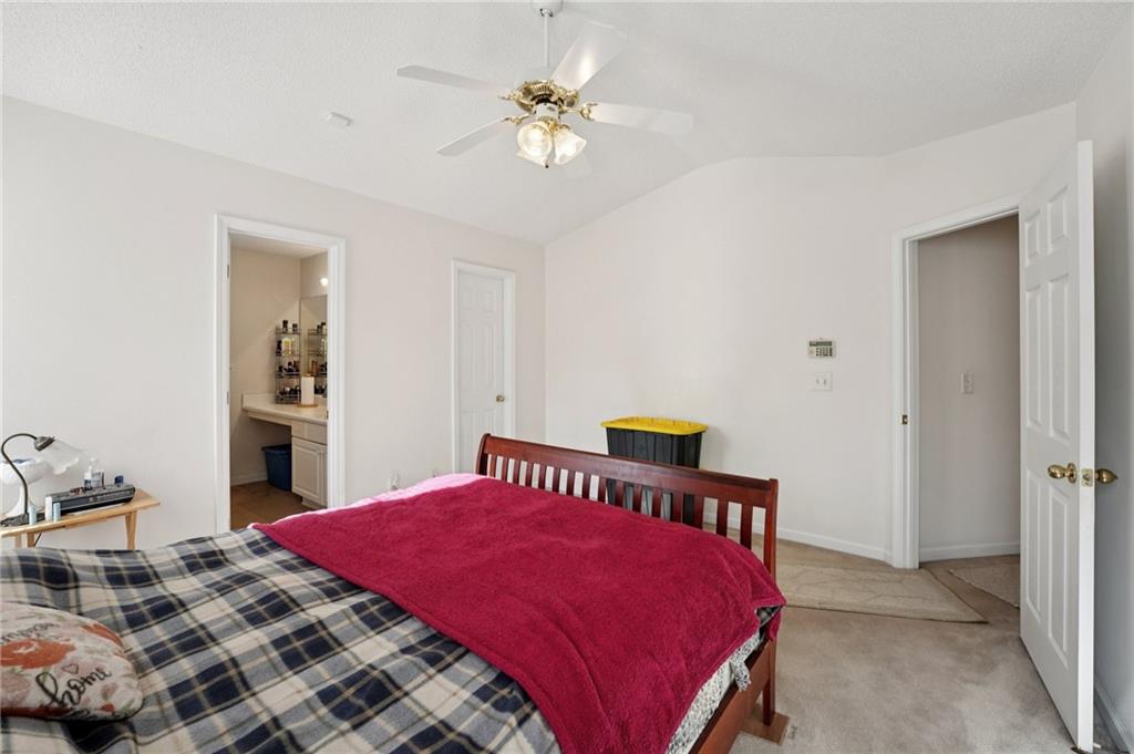 111 Bainbridge Court Dallas, GA 30132 - Photo 15 of 37 a bedroom with a bed and a chandelier