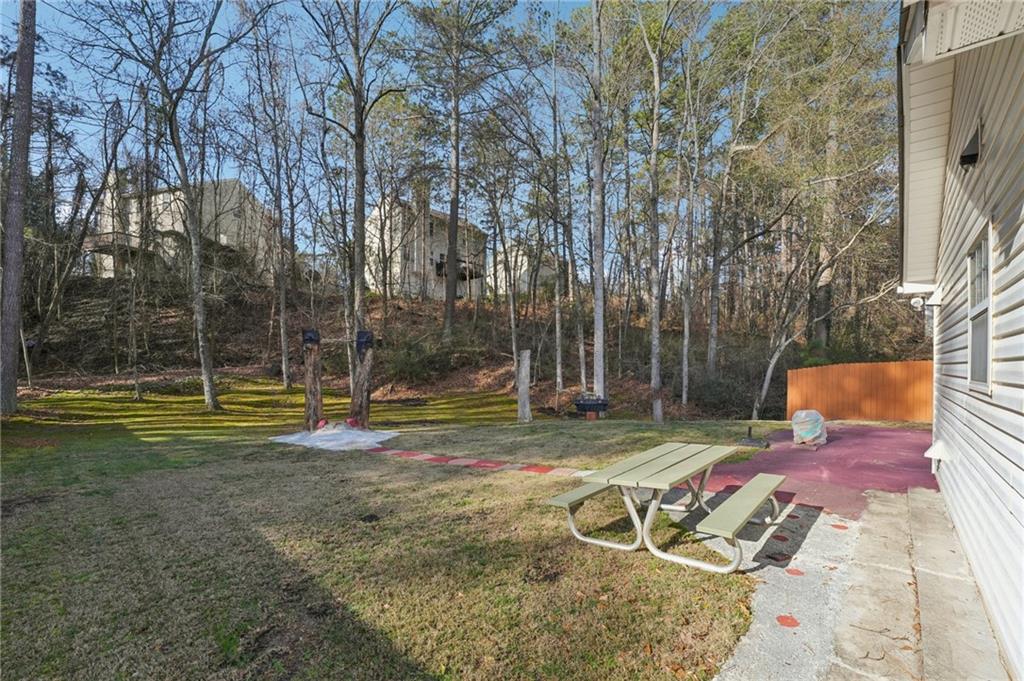 111 Bainbridge Court Dallas, GA 30132 - Photo 25 of 37 a view of a backyard with a table and chairs