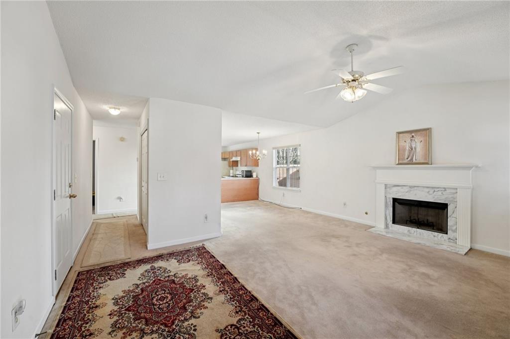 111 Bainbridge Court Dallas, GA 30132 - Photo 4 of 37 a view of a livingroom with a fireplace a ceiling fan and wooden floor