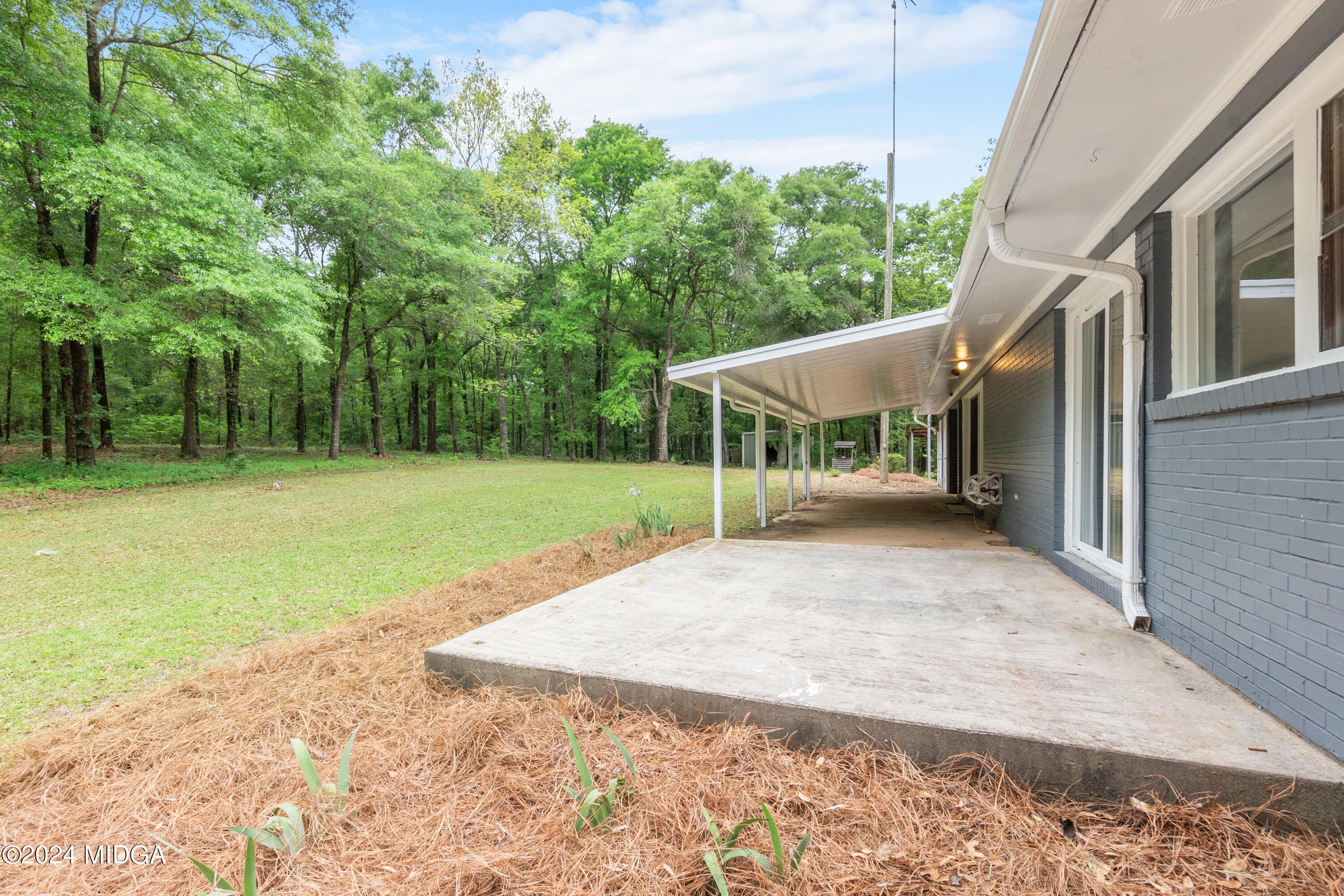 711 Country Club Road Fort Valley, GA 31030 - Photo 18 of 20 a view of a house with backyard and sitting area