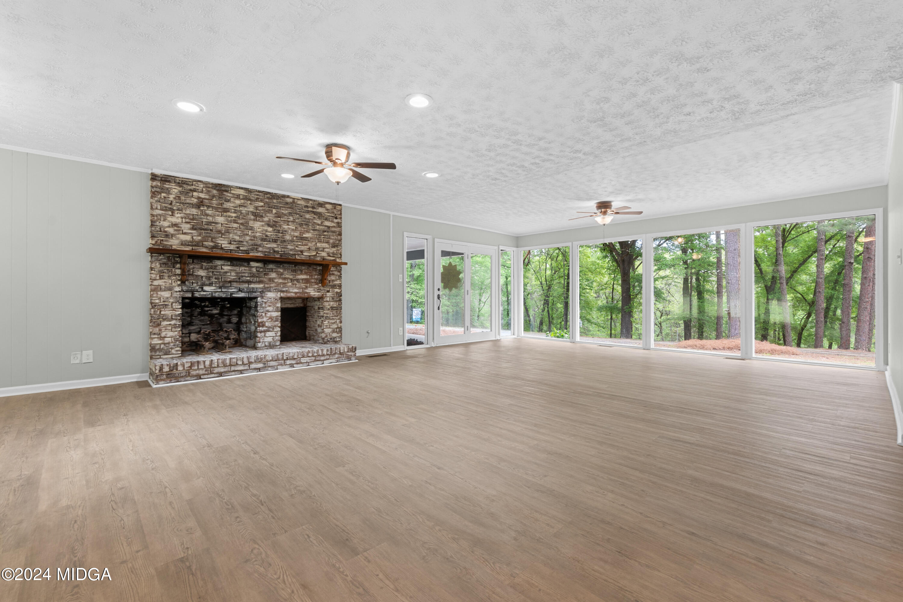711 Country Club Road Fort Valley, GA 31030 - Photo 6 of 20 a view of empty room with fireplace and windows