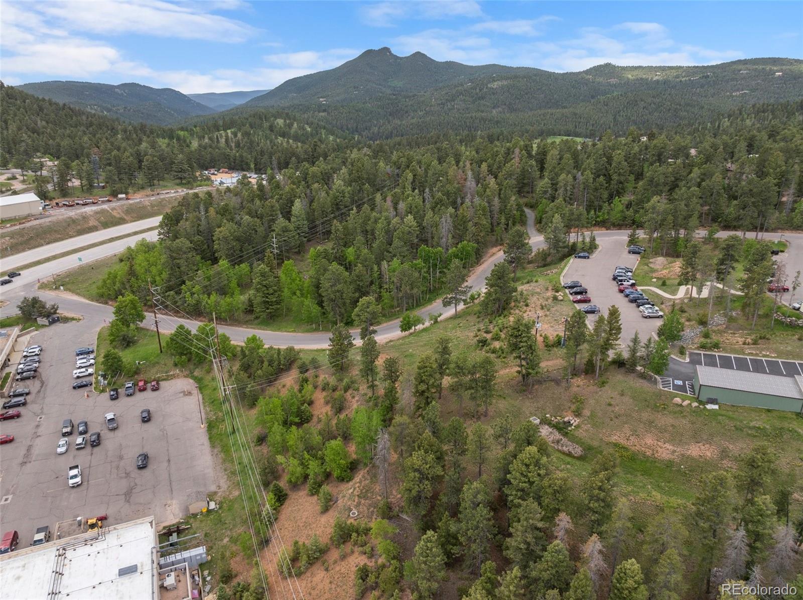 11040 Kitty Drive Conifer, CO 80433 - Photo 7 of 14 a view of a town with mountains in the background