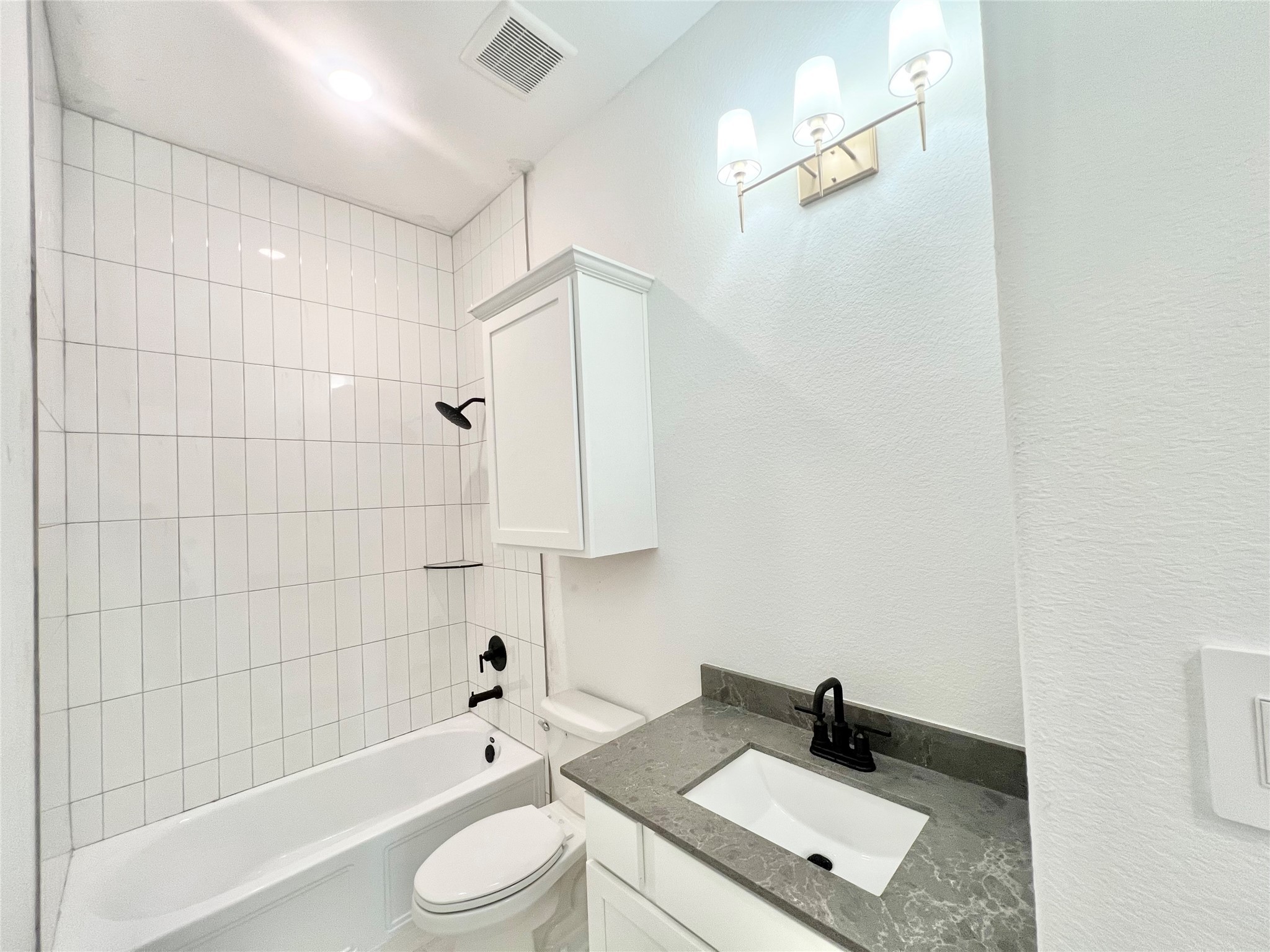 15722 North Tower Circle Santa Fe, TX 77517 - Photo 15 of 30 Bathroom 2 will have wood paneling feature wall, oval mirrors, and brushed gold cabinet hardware