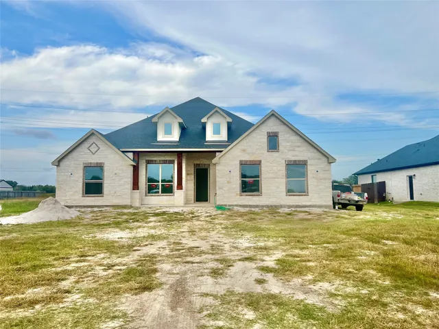 a view of a house with a yard and garage