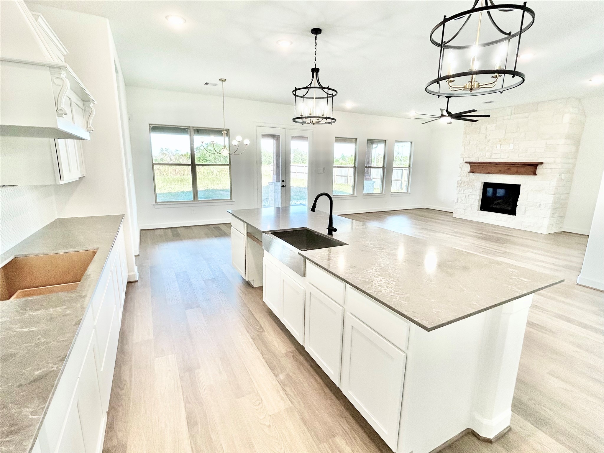 15722 North Tower Circle Santa Fe, TX 77517 - Photo 7 of 30 a kitchen with kitchen island granite countertop a stove a sink and dishwasher with wooden floor