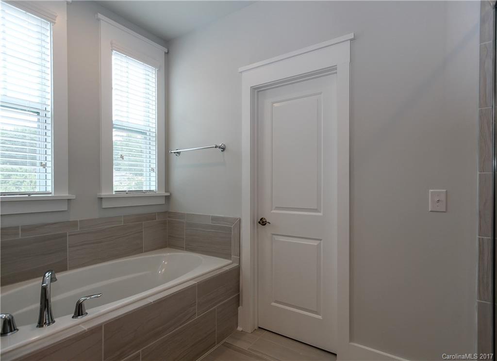 904 Millbrook Road, Unit 7A Charlotte, NC 28211 - Photo 12 of 22 a white bath tub sitting next to a white sink