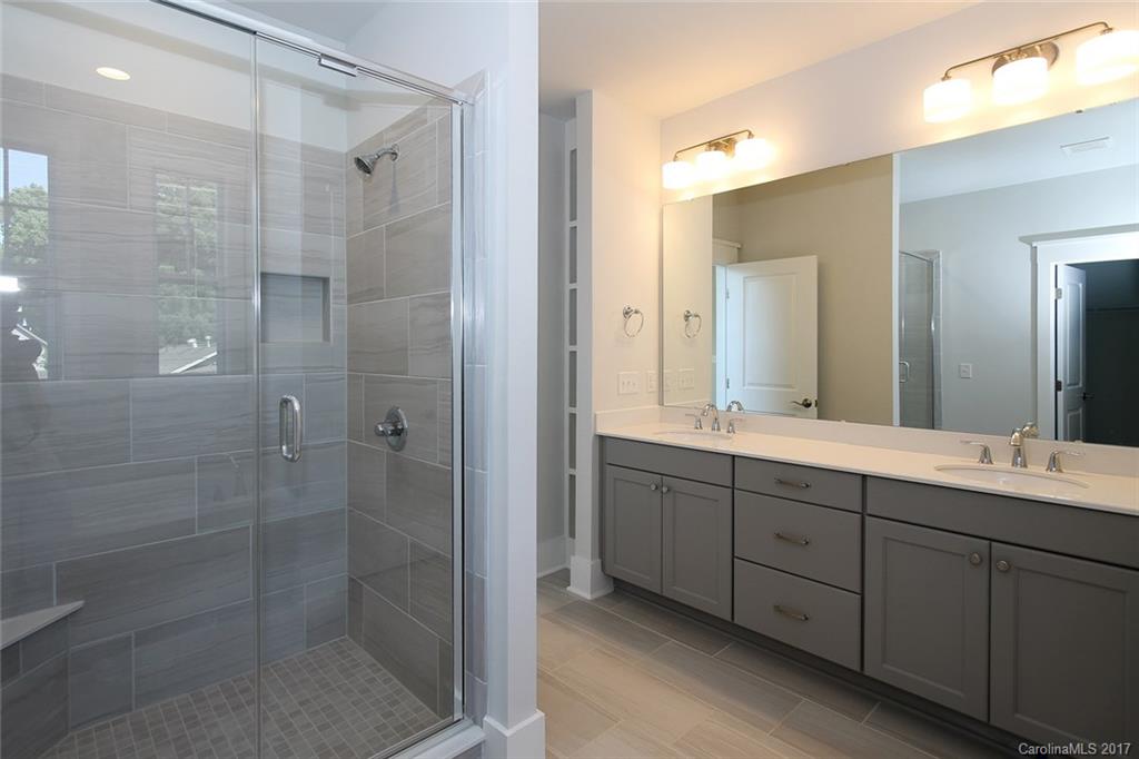 904 Millbrook Road, Unit 7A Charlotte, NC 28211 - Photo 13 of 22 a bathroom with double sink shower and two mirror