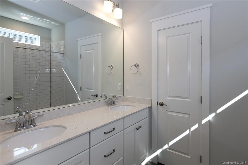 904 Millbrook Road, Unit 7A Charlotte, NC 28211 - Photo 15 of 22 a bathroom with a double vanity sink and a mirror