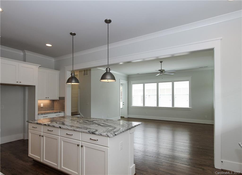 904 Millbrook Road, Unit 7A Charlotte, NC 28211 - Photo 7 of 22 a open kitchen with stainless steel appliances granite countertop a stove and a wooden floors