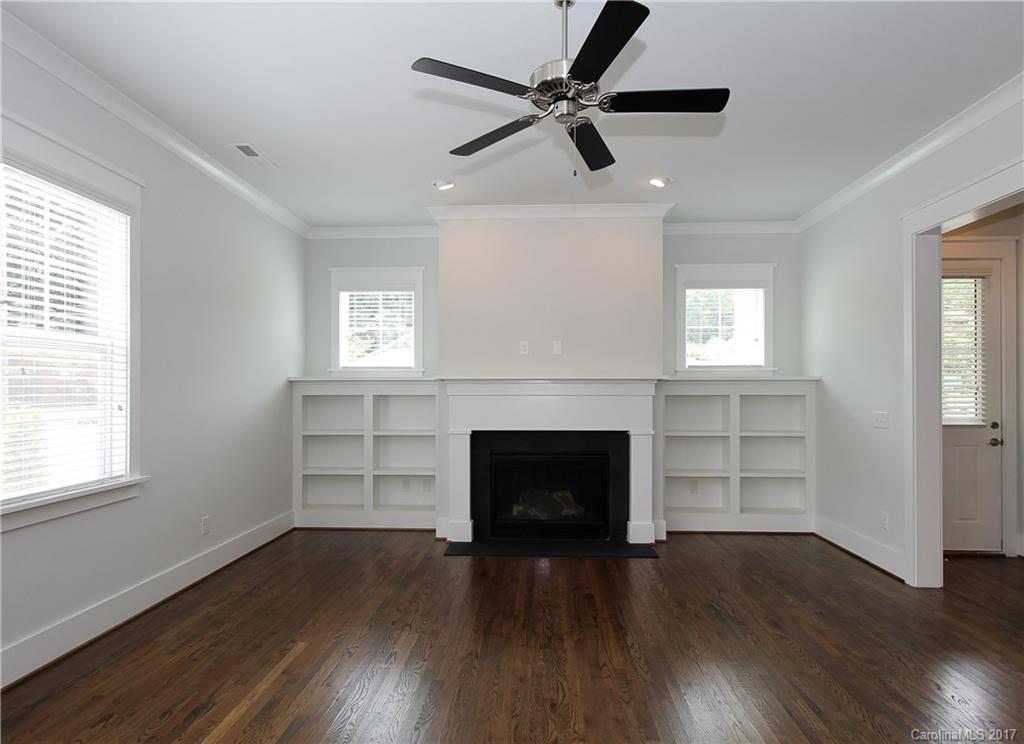 904 Millbrook Road, Unit 7A Charlotte, NC 28211 - Photo 8 of 22 wooden floor fireplace and windows in an empty room