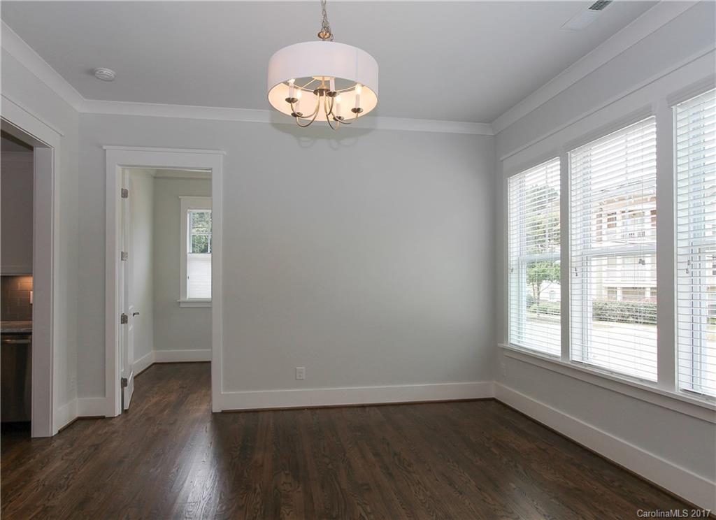 904 Millbrook Road, Unit 7A Charlotte, NC 28211 - Photo 10 of 22 an empty room with wooden floor and windows