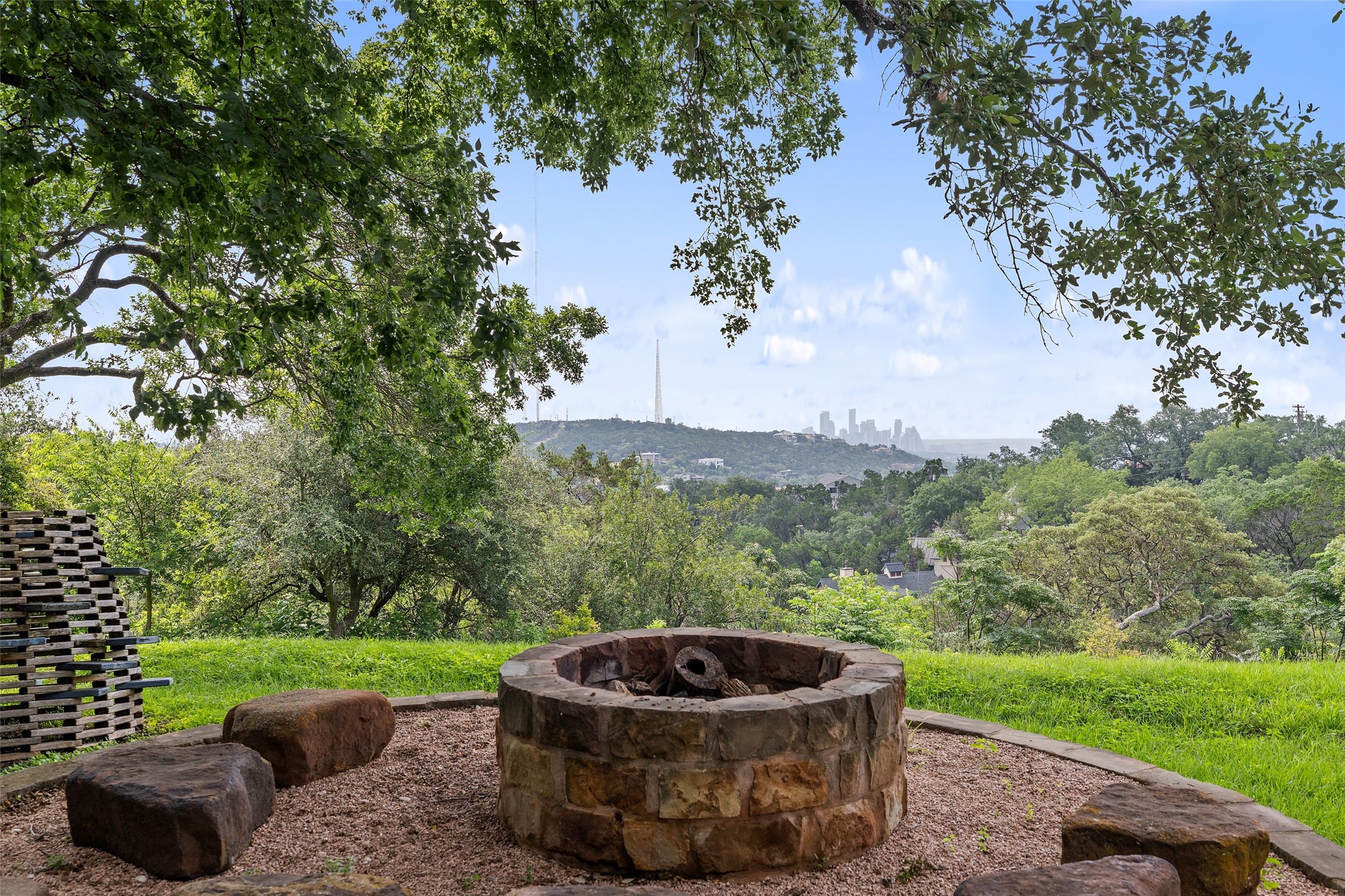 1414 The High Road Austin, TX 78746 - Photo 6 of 40 A stone fire pit surrounded by natural rock seating offers panoramic city and greenbelt views.