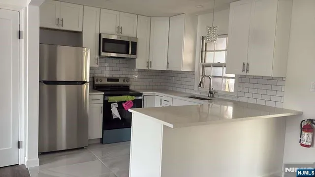 a view of a kitchen with a sink and a window
