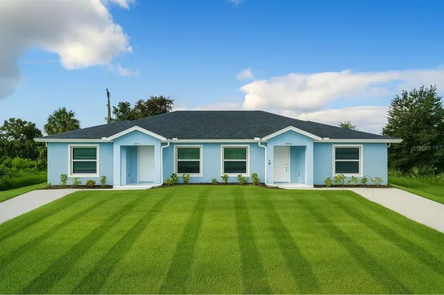 a front view of a house with a garden