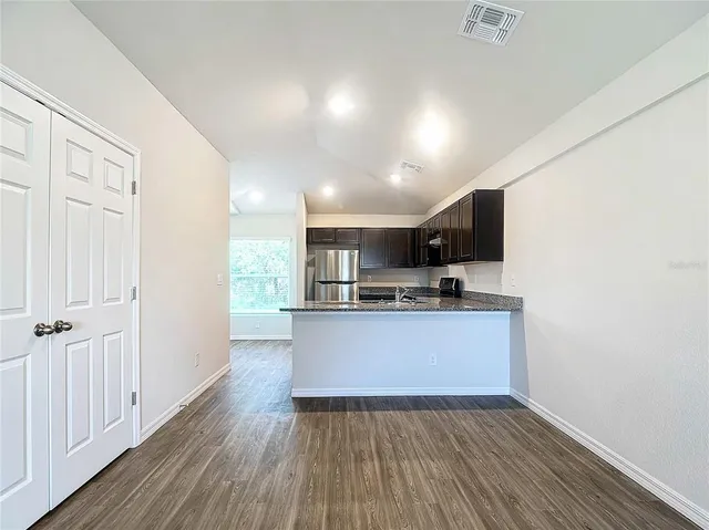 a view of kitchen with sink and wooden floor
