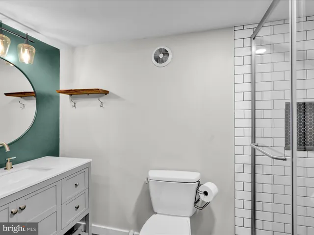 a bathroom with a toilet sink and mirror
