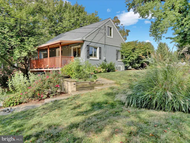 a aerial view of a house with yard and green space