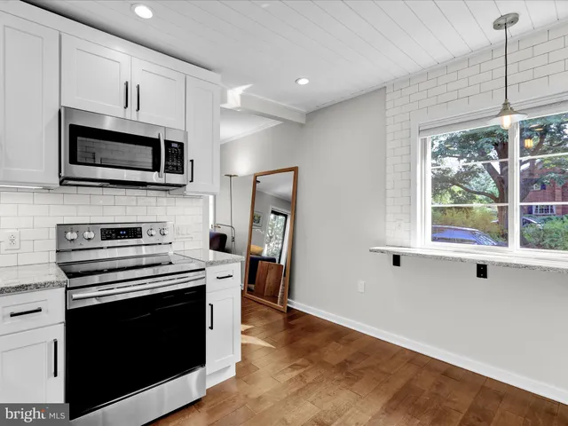 a kitchen with stainless steel appliances a stove microwave and refrigerator