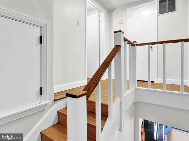 a view of entryway with wooden floor and stairs