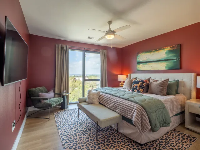 a balcony with wooden floor table and chairs