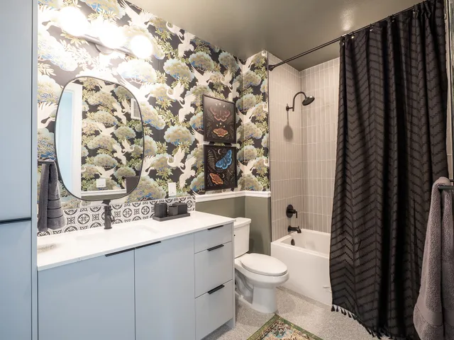 a bedroom with bed and painting on the wall