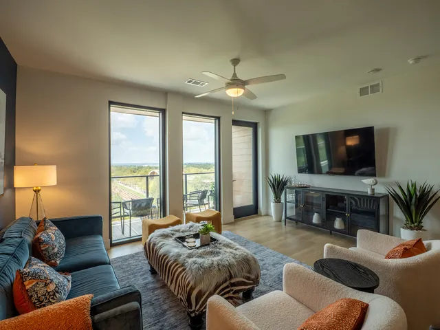 a living room with furniture and a chandelier