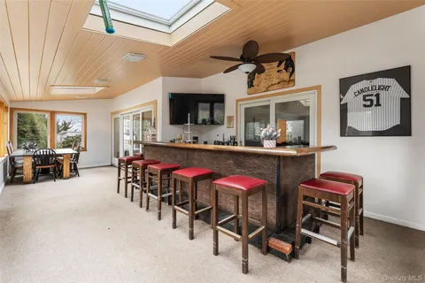 a dinning area with furniture and a flat screen tv