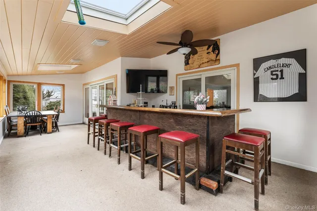 a dinning area with furniture and a flat screen tv