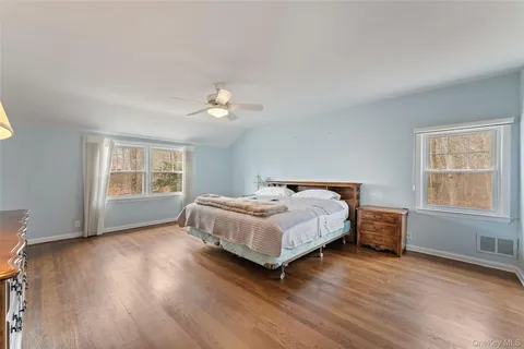 a bedroom with a bed lamp closet and window