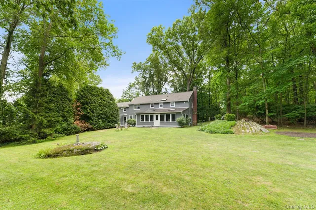 a view of a house with a yard and sitting area