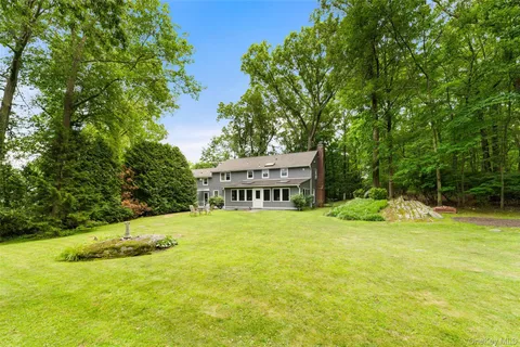 a view of a house with a yard and sitting area