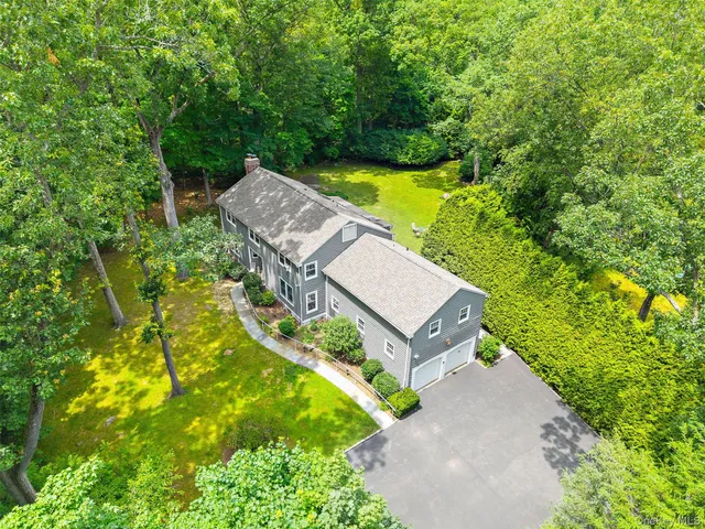 an aerial view of a house with a yard