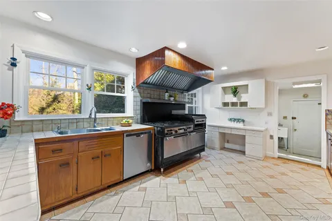 a kitchen with a sink cabinets and window