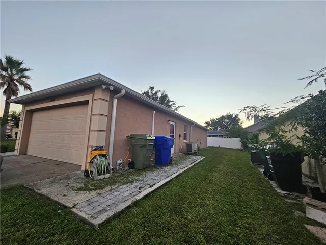 a front view of house with a garden and plants